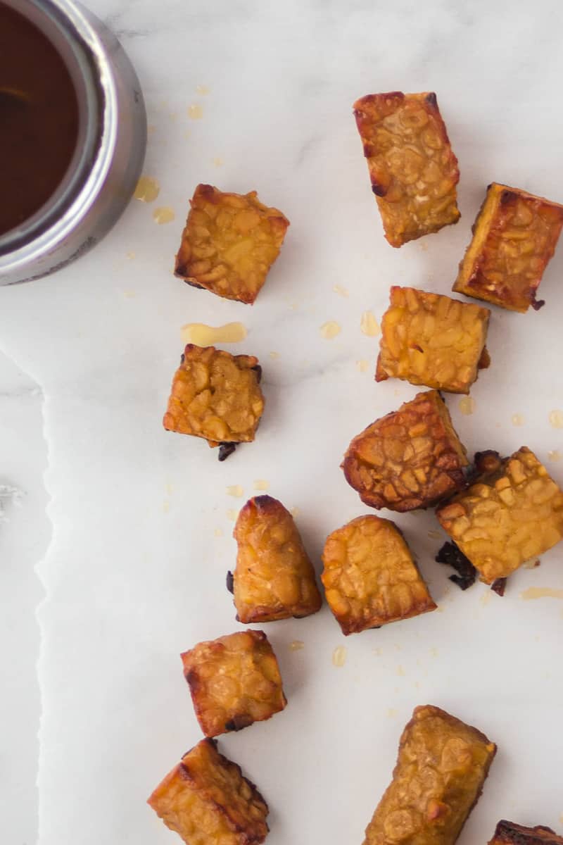 Close-up shot of pieces of cooked tempeh that have been marinated