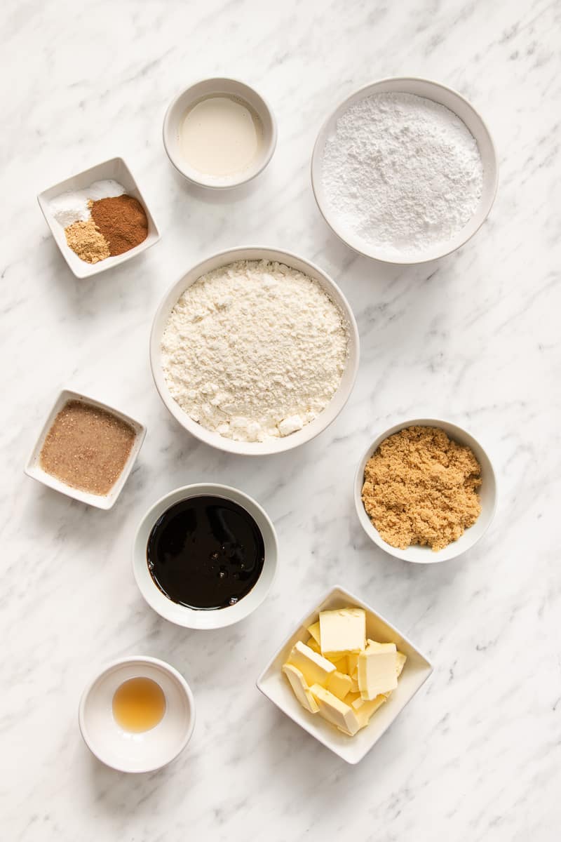 Bowls of butter, brown sugar, ground ginger, cinnamon, salt, molasses, vanilla extract, gluten-free flour, and a flax egg