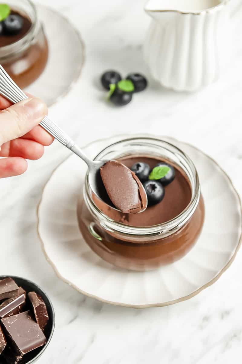 Close-up shot of a spoonful of panna cotta over a cup of panna cotta