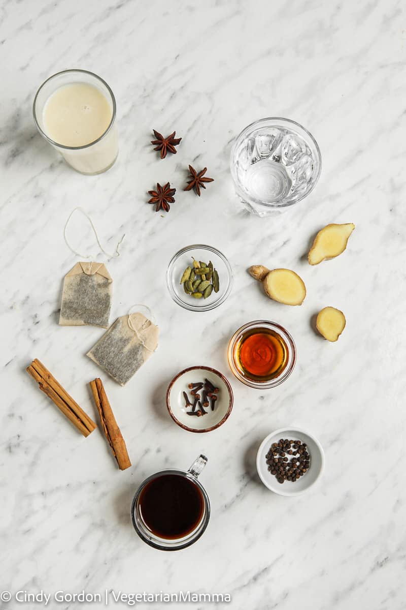 individual ingredients laid out for the dirty chai latte, all on a white marble board.