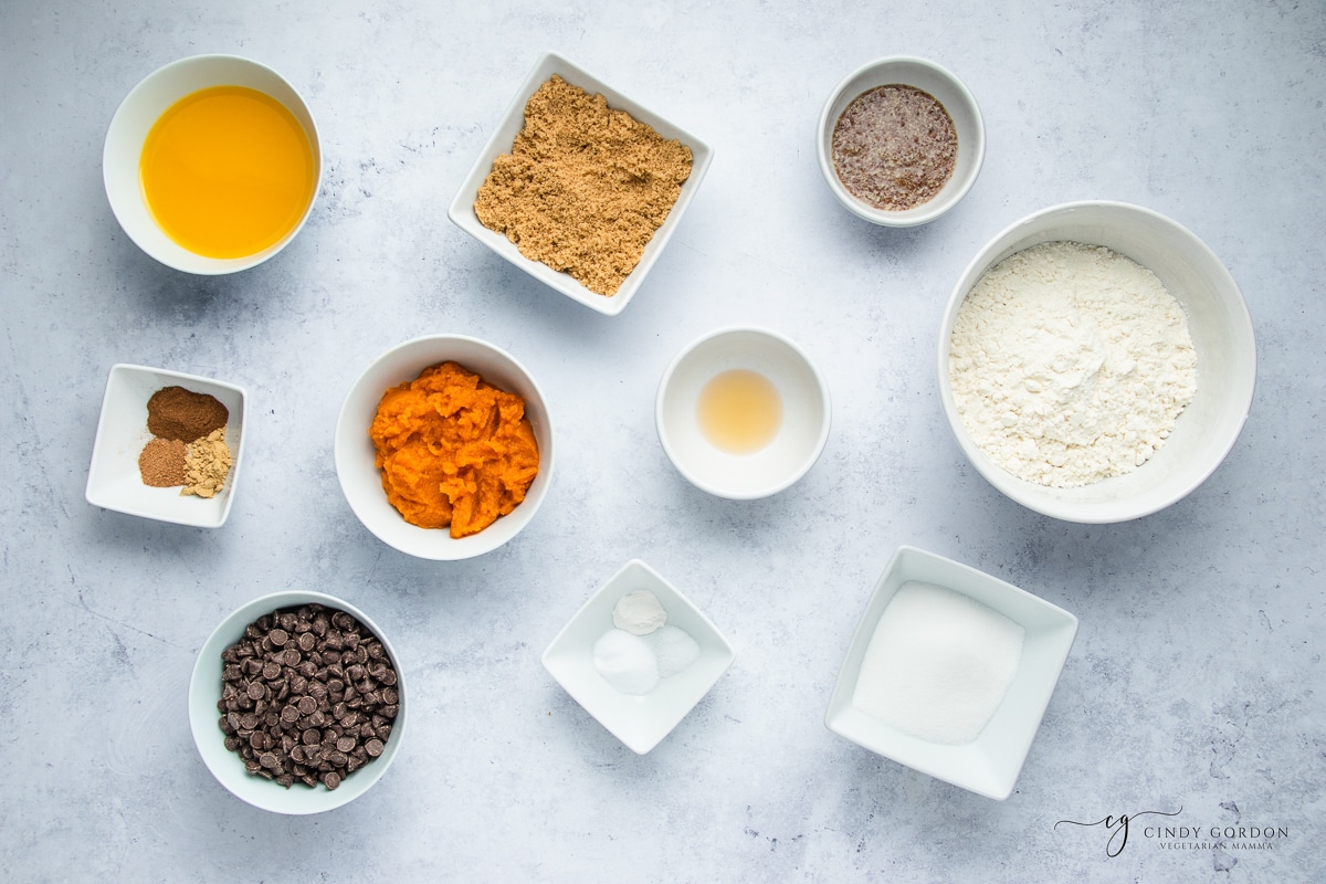 Bowls of flour, spices, pumpkin, vegan butter, brown sugar, caster sugar, and chocolate chips