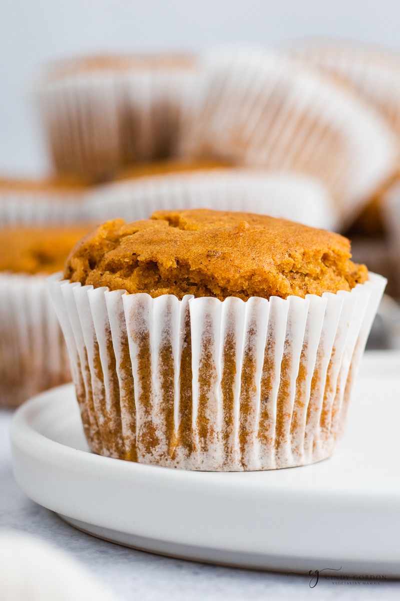 Close-up shot of a pumpkin muffin in a white cupcake wrapper