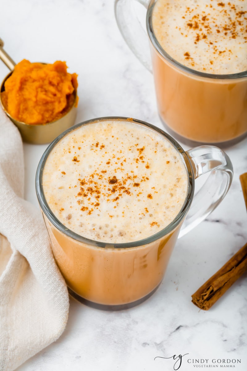 Overhead shot of a pumpkin spiced latte sprinkled with more pumpkin pie spice