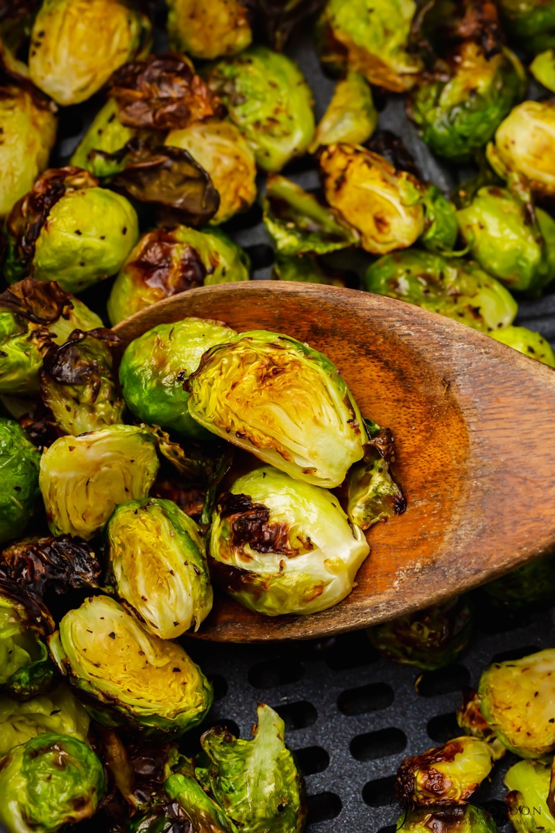 air fryer brussel sprouts close up with wooden spoon