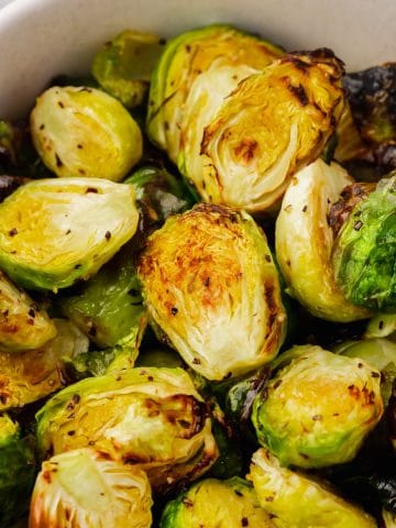 Air Fryer Brussel Sprouts inside of white bowl close up