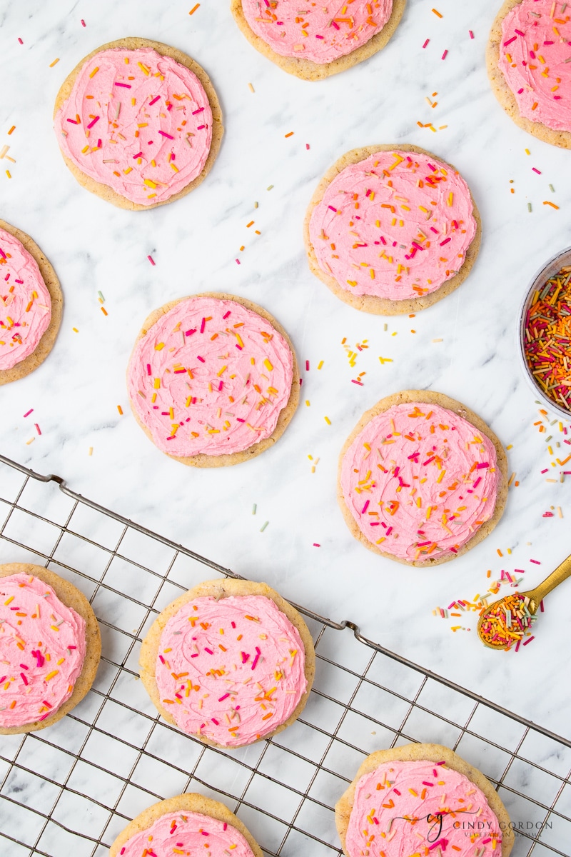 Vegan frosted sugar cookies on a wire rack