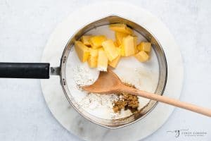 butter, sugar and flour in a saucepan with a wooden spoon