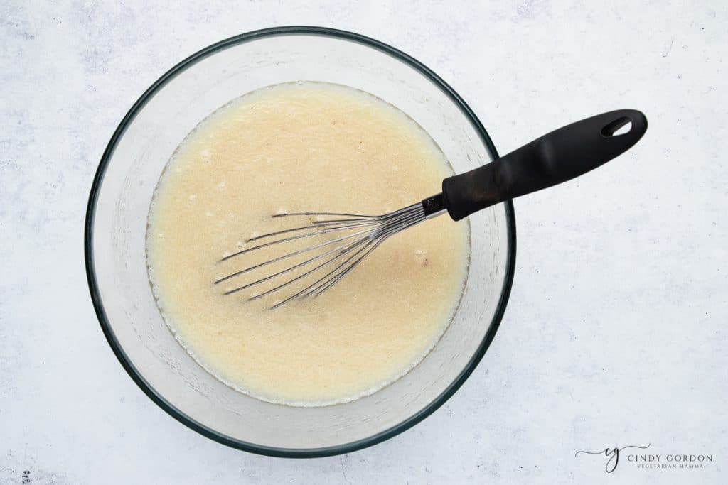 wet ingredients in a bowl with a whisk.