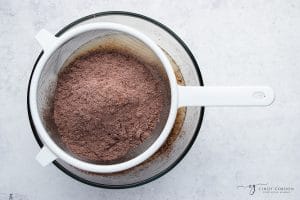 cocoa and flour, sifting into a bowl