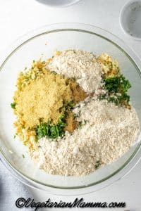 In a large mixing bowl, mix the blended zucchini and carrots with all other fritter ingredients. Mix well.