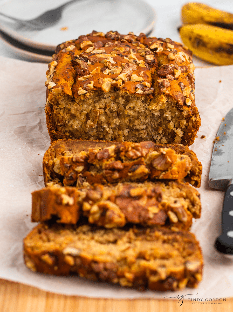 Close-up shot of a sliced loaf of no sugar banana bread with walnuts