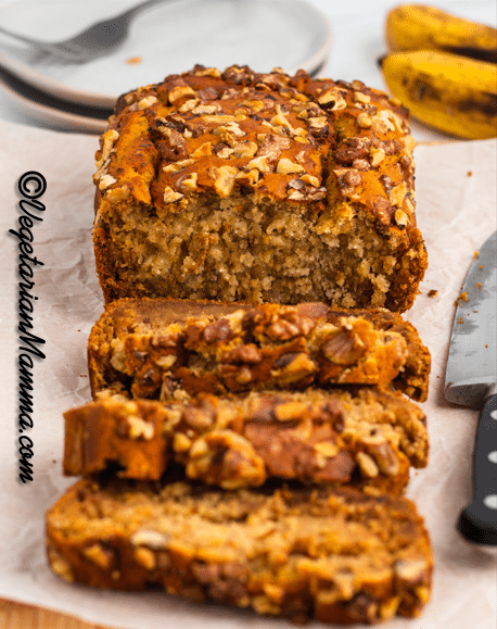 Close-up shot of a sliced loaf of no sugar banana bread with walnuts