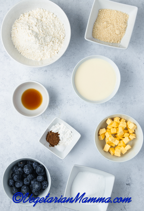 The ingredients for making vegan blueberry scones were measured into small bowls and set on a marble counter