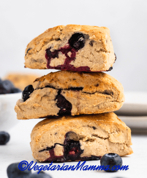 A stack of three fluffy vegan blueberry scones.
