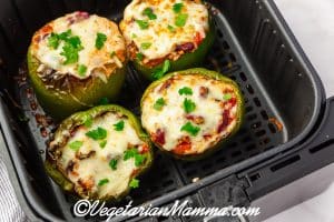 four green peppers with melted cheese.