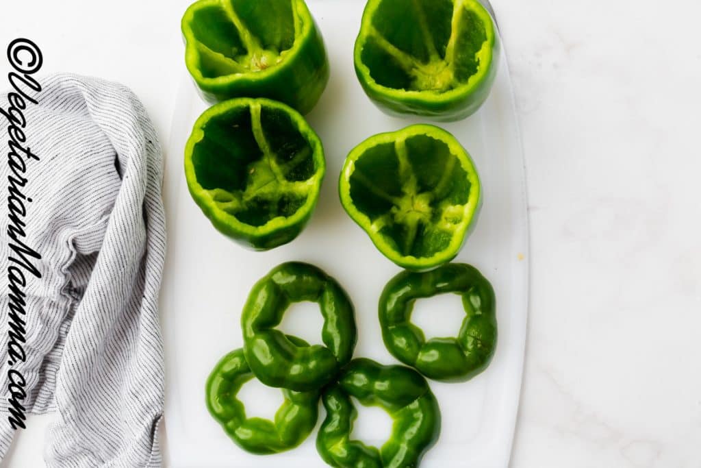 Green peppers washed, centers cleaned, and the tops removed.