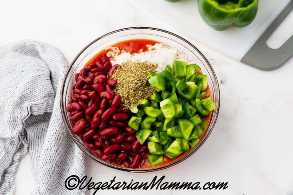 A combination of beans, green pepper tops, and sauce.