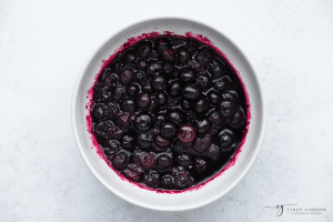 white bowl with blueberry sauce