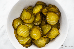 green pickle circles in a white bowl