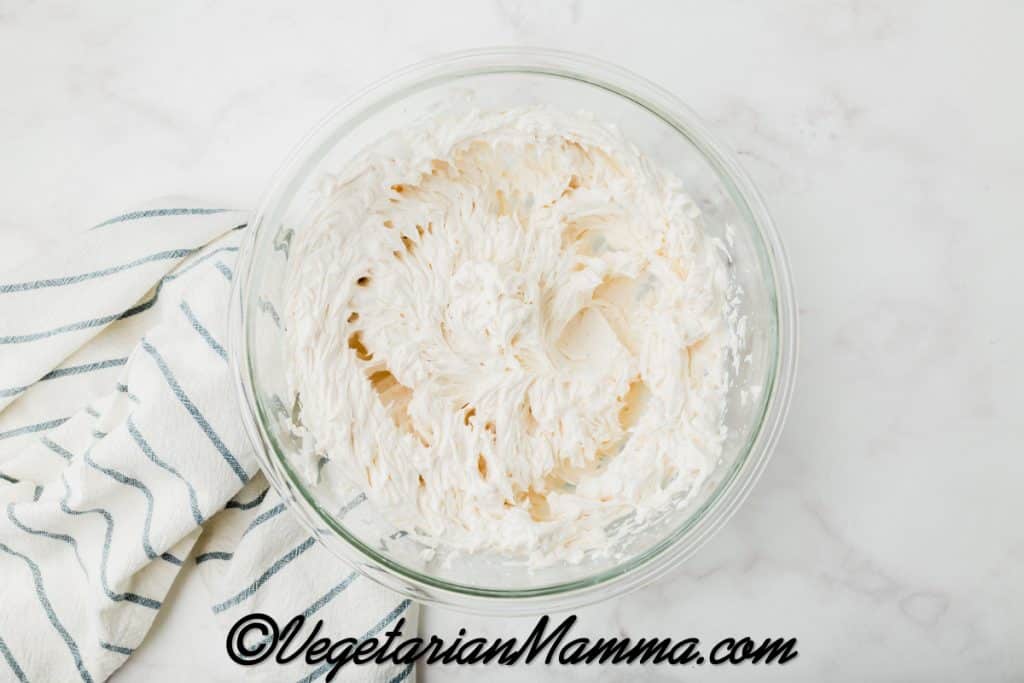add the vegan cream cheese. Beat with an electric mixer until soft and creamy, 2-3 minutes.