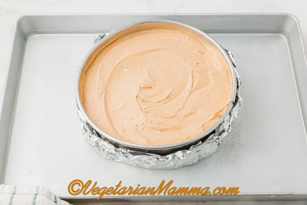 Add very hot (almost boiling) water to the baking dish until it reaches halfway up the side of the springform pan. Carefully place in the oven.