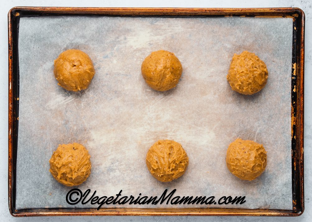 Roll the dough into balls. Place them on lined baking sheets.