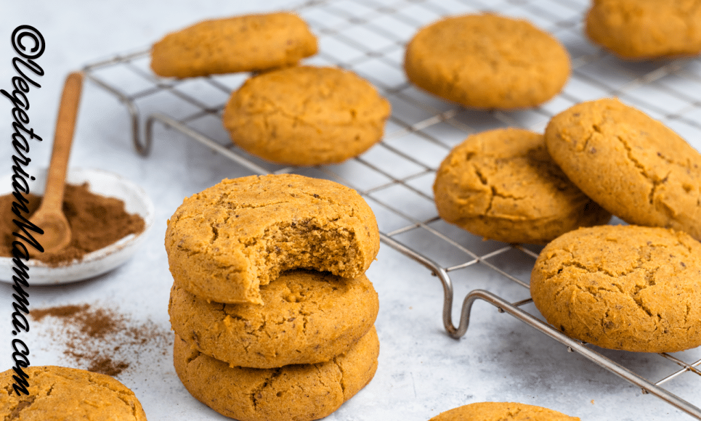 Pumpkin cookies on a wire sheet to cool.