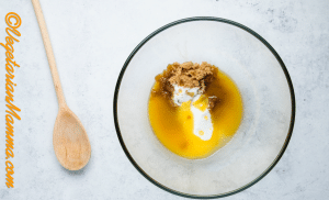 Add melted butter, brown sugar, and caster sugar to a mixing bowl.