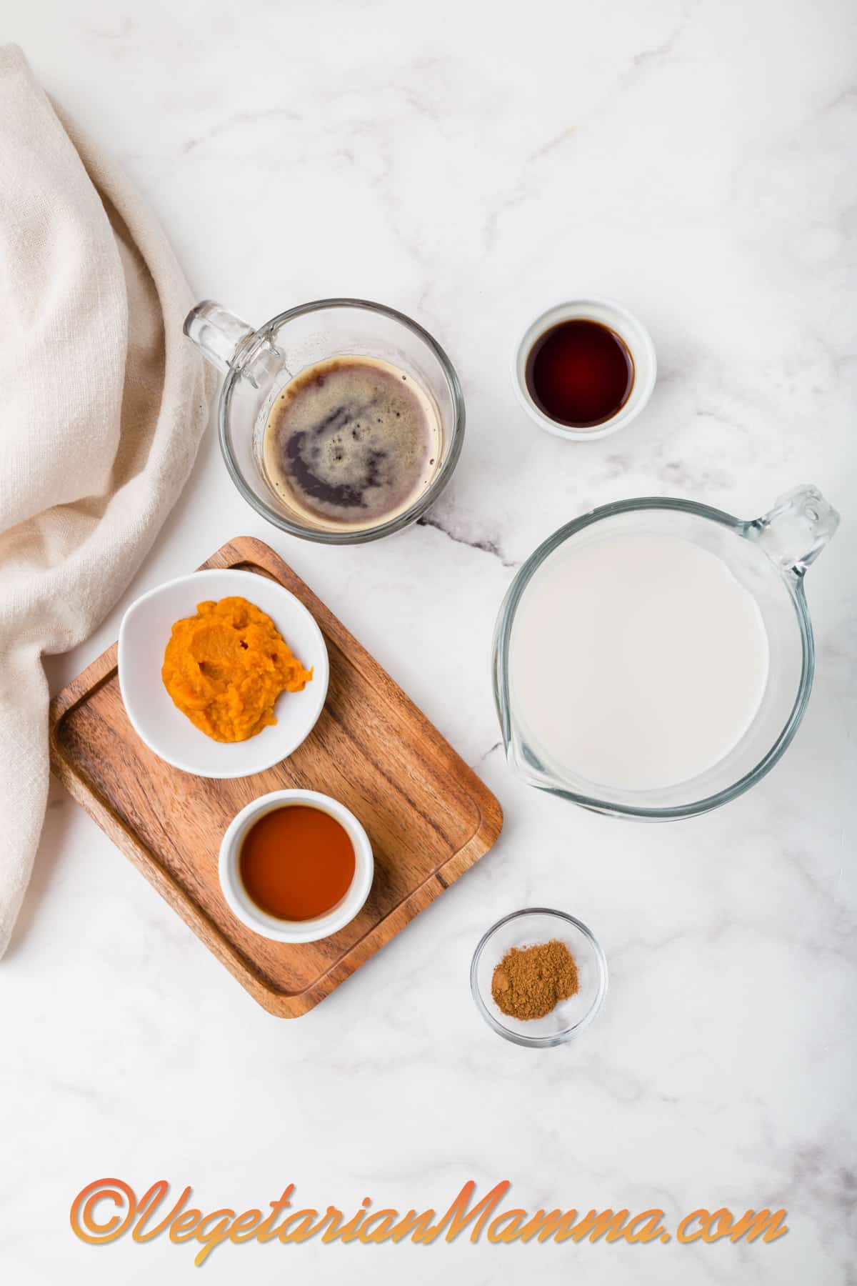 Bowls of non-dairy milk, pumpkin puree, maple syrup, vanilla extract, espresso, and pumpkin pie spice