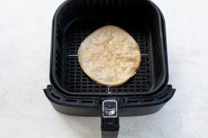 Air Fryer Quesadilla in a black air fryer basket