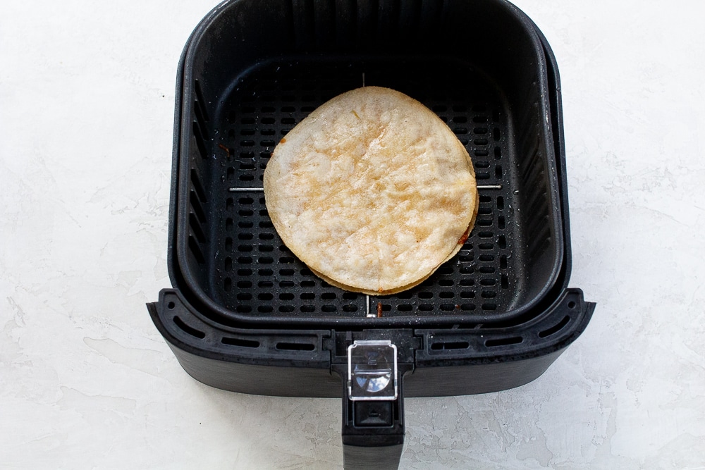Air Fryer Quesadilla in a black air fryer basket