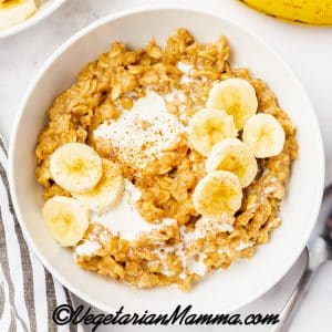 white bowl filled with brown oatmeal and sliced bananas