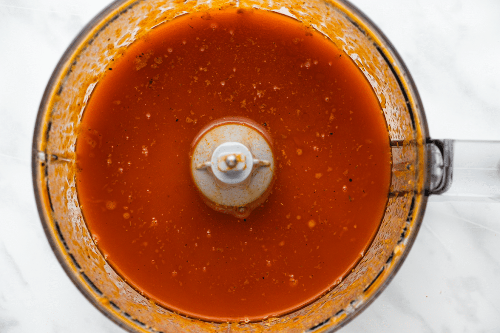 red color liquid in food processor, overhead shot down