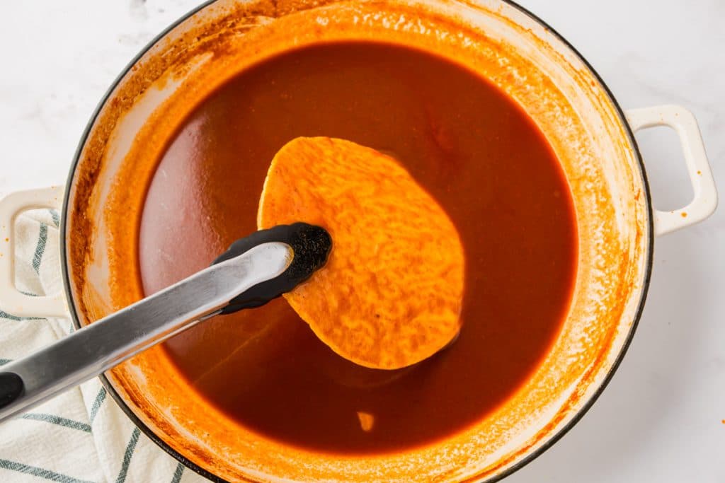 red sauce in clear bowl with silver spoon