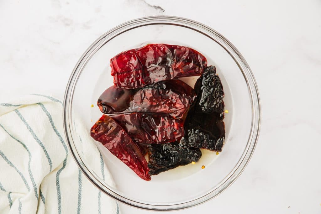 peppers soaking in liquid in clear bowl