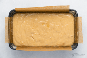 dairy free banana bread liquid in a parchment lined bread pan