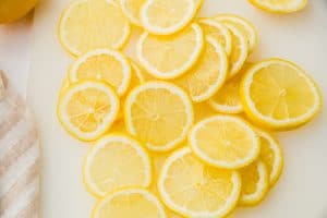 lots of lemon slices on white cutting board