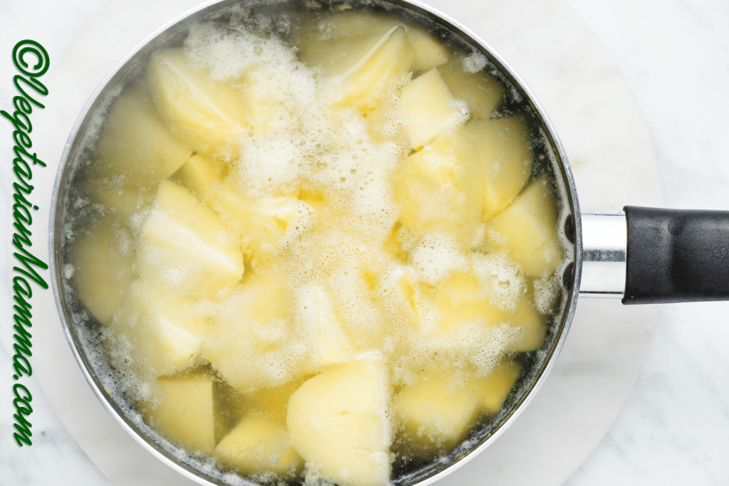 Chopped potatoes in a pan covered with water.