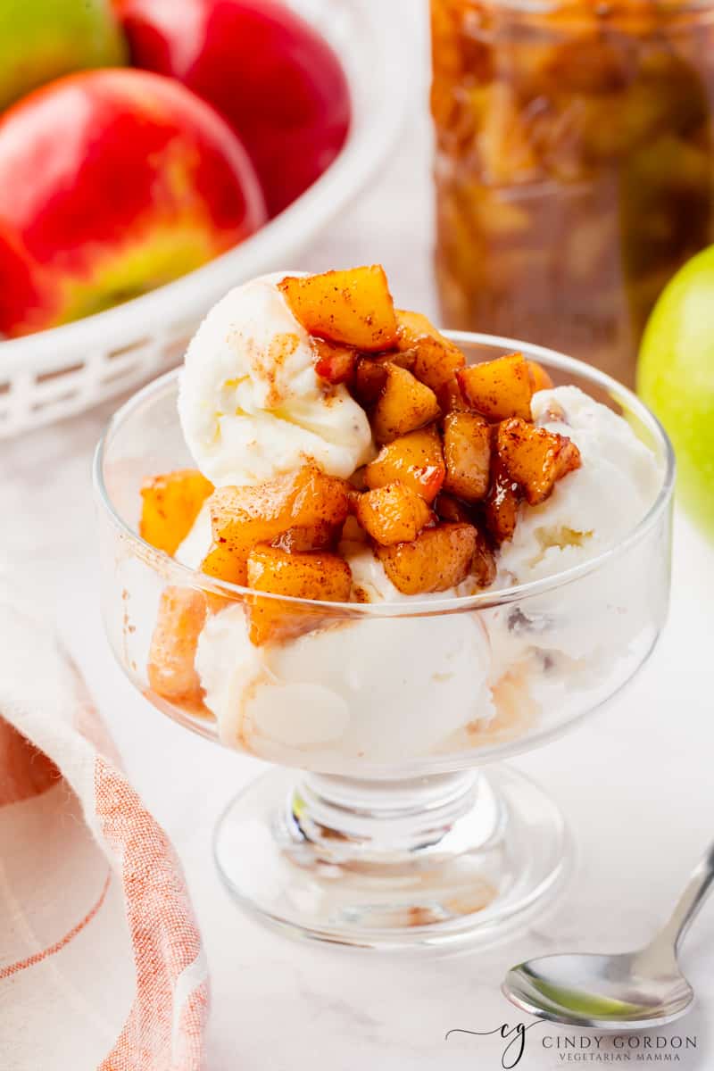 a footed dish of vanilla ice cream topped with cinnamon apple compote