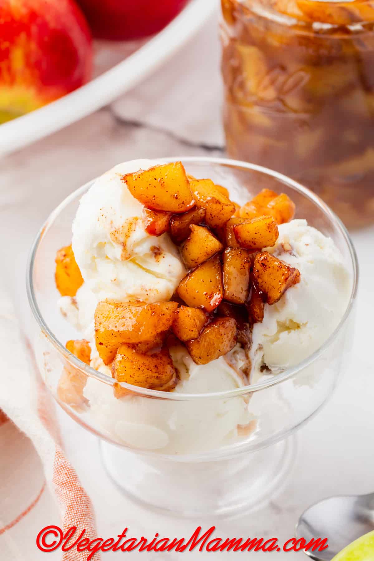 a footed dish of vanilla ice cream topped with cinnamon apple compote