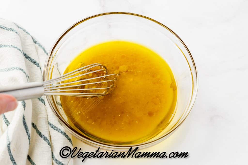 Add the olive oil, apple cider vinegar, honey, lemon juice, dijon mustard, and salt to a mason jar or bowl.