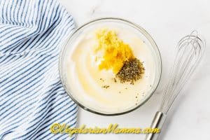 Add the garlic to a bowl with the mayonnaise, lemon juice, lemon zest, salt and ground black pepper.