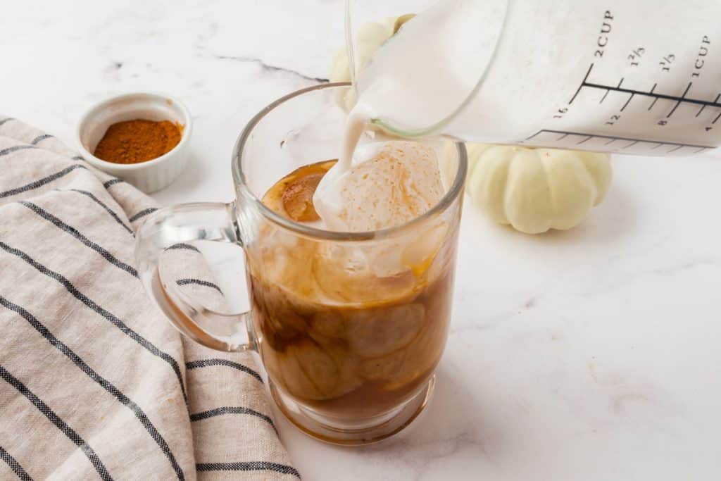 Milk added to an iced pumpkin spice latte