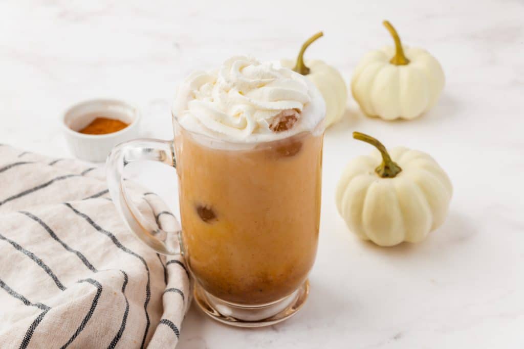 a finished pumpkin spice latte with whipped cream on top