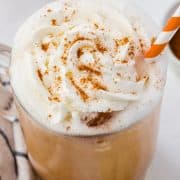 closeup of the top half of an iced pumpkin spice latte with whip