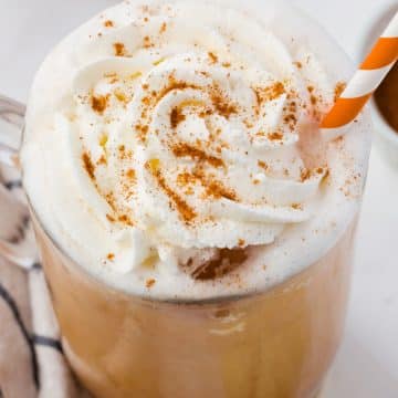 closeup of the top half of an iced pumpkin spice latte with whip