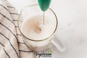 Add the milk to a separate mug or jar and froth until foamy.