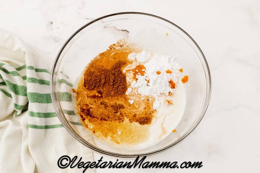 Add the heavy cream, pumpkin puree, powdered sugar, vanilla extract and pumpkin pie spice to a mixing bowl.