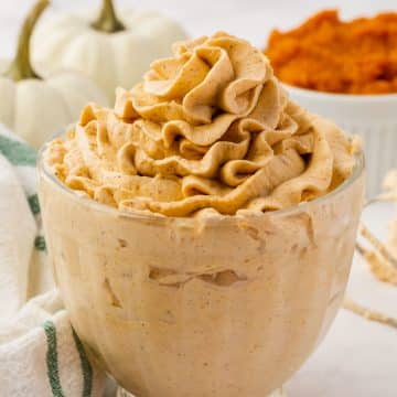 A small glass of pumpkin whipped cream.