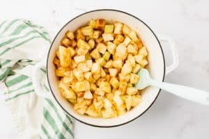 diced apples in a pan mixed with cinnamon lemon juice and water